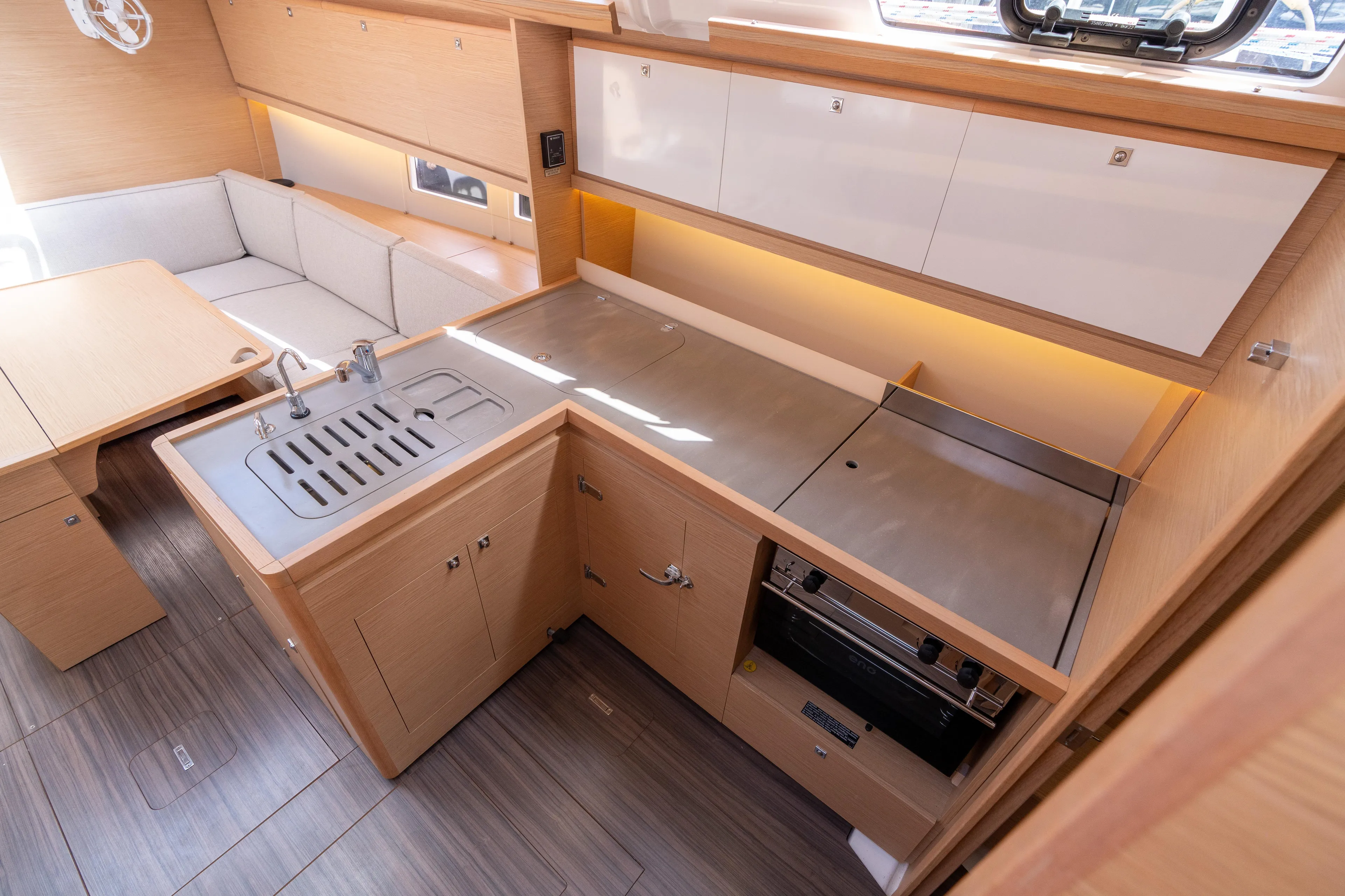 Lunar Sea Yacht Photos Pics Modern kitchen interior of 2023 Dufour 390 yacht with sleek cabinetry and appliances.