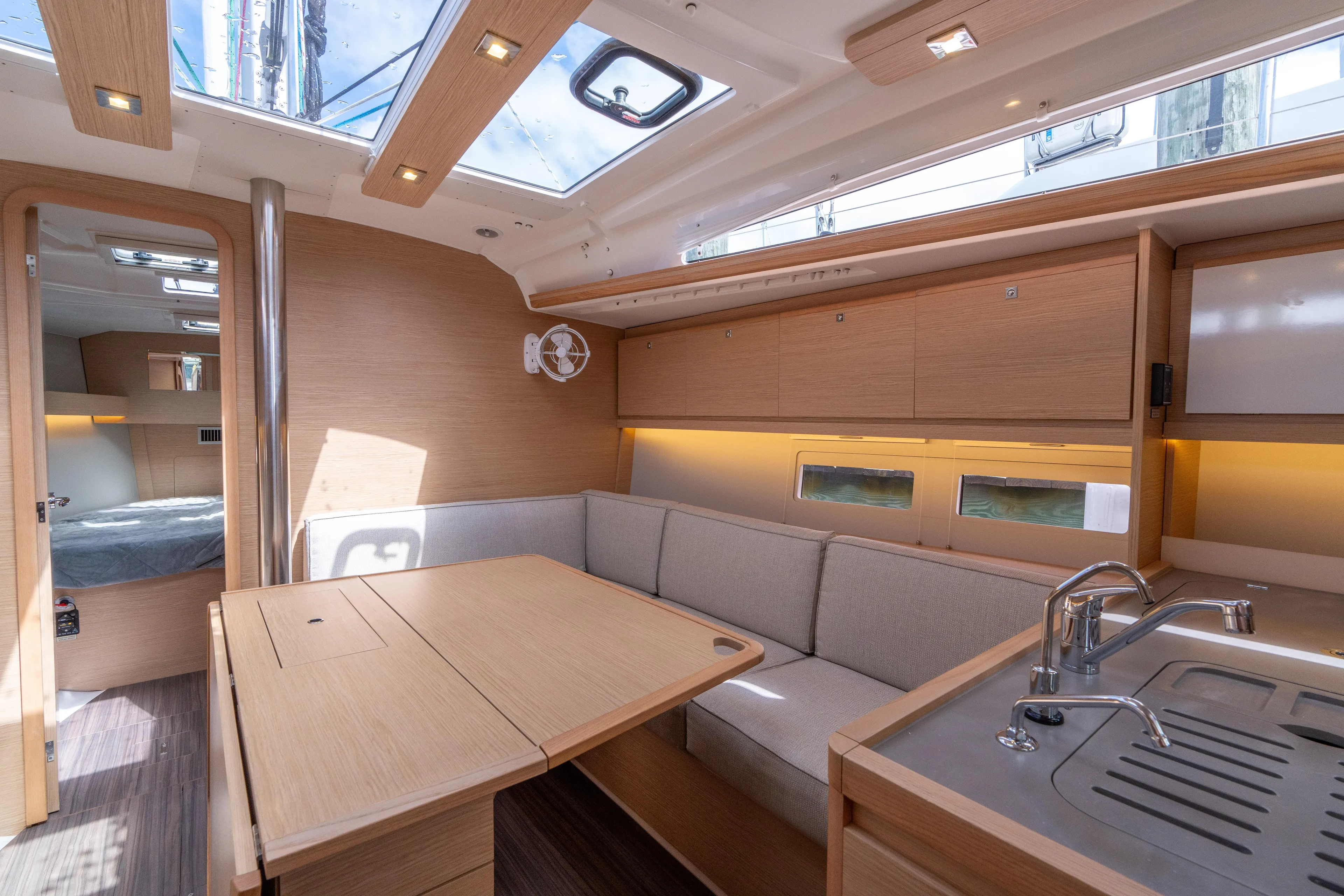 Lunar Sea Yacht Photos Pics 2023 Dufour 390 yacht interior with modern kitchen, dining area, and cozy cabin.