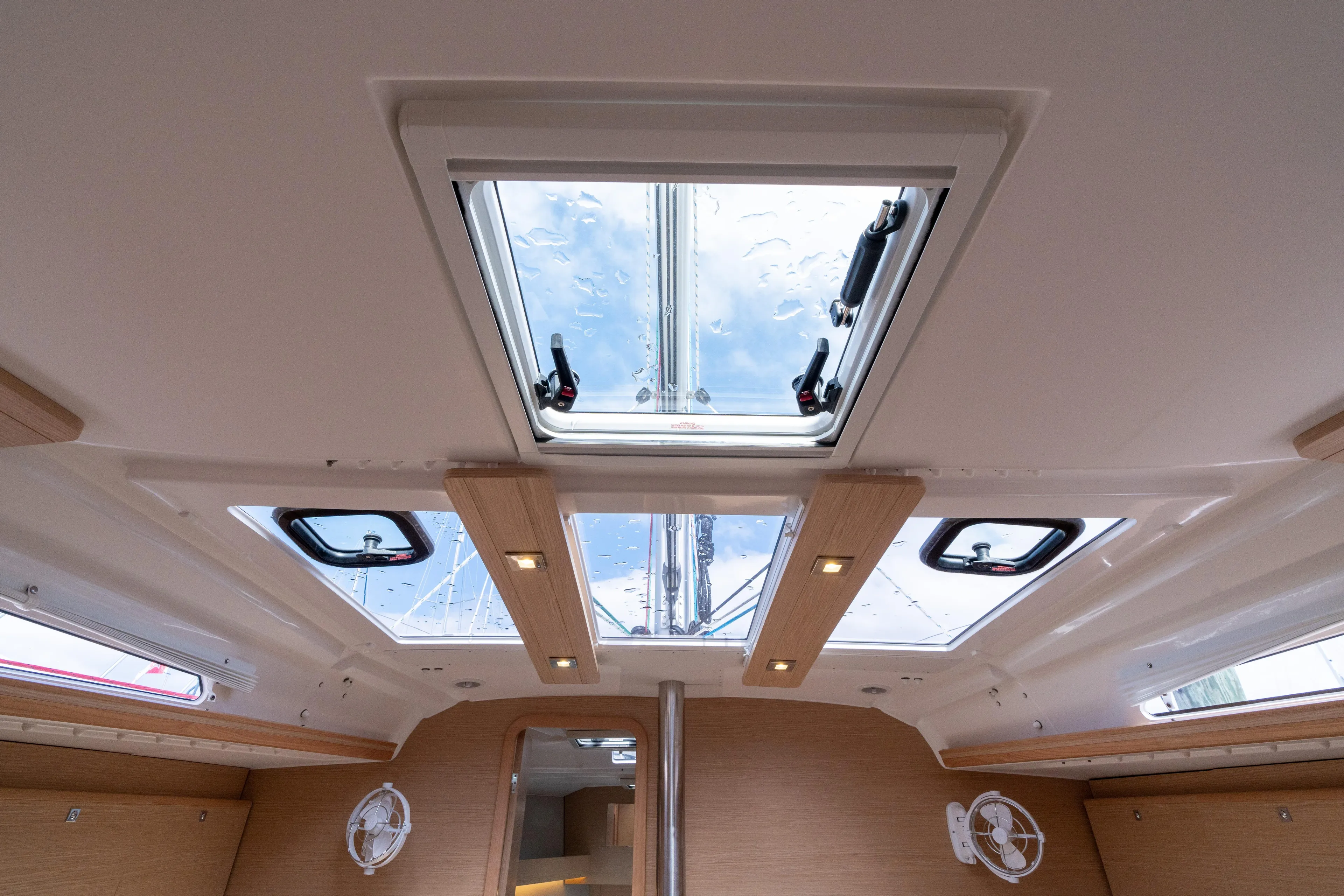 Lunar Sea Yacht Photos Pics Interior view of 2023 Dufour 390 yacht, featuring skylights and modern wood accents.