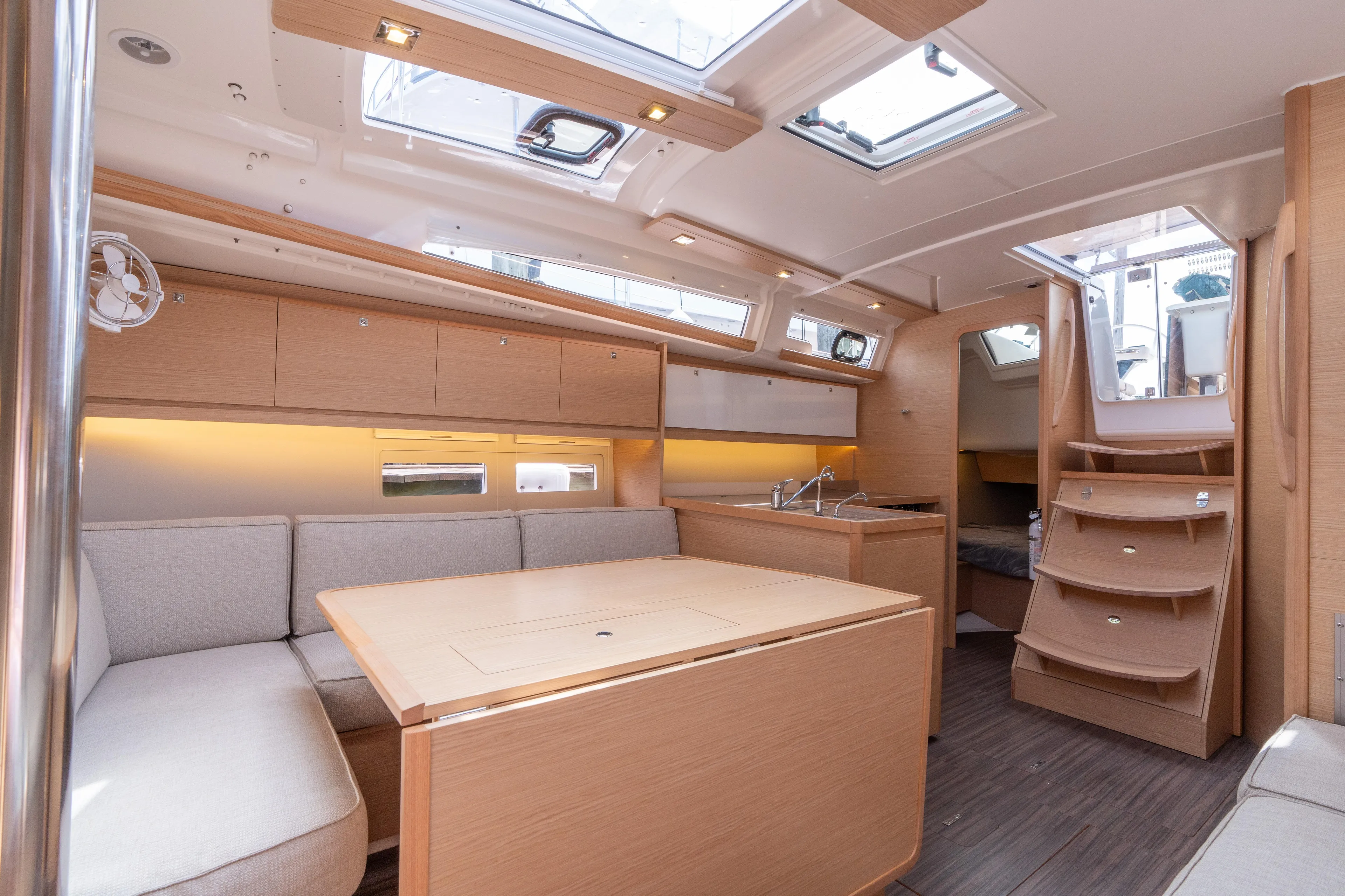 Lunar Sea Yacht Photos Pics Modern interior of 2023 Dufour 390 yacht with spacious seating and elegant wood finish.