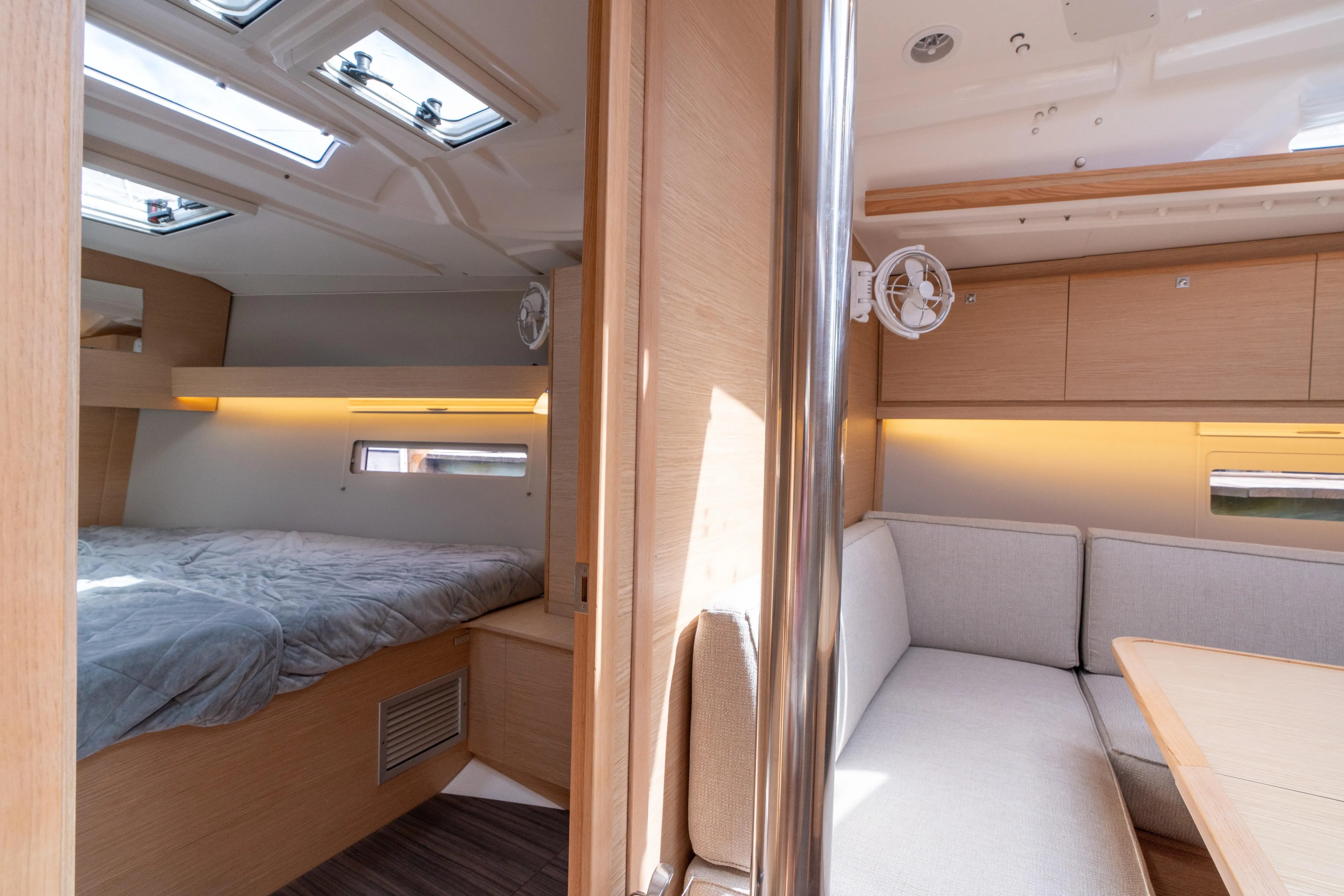 Lunar Sea Yacht Photos Pics 2023 Dufour 390 yacht interior with cozy bedroom and modern seating area.