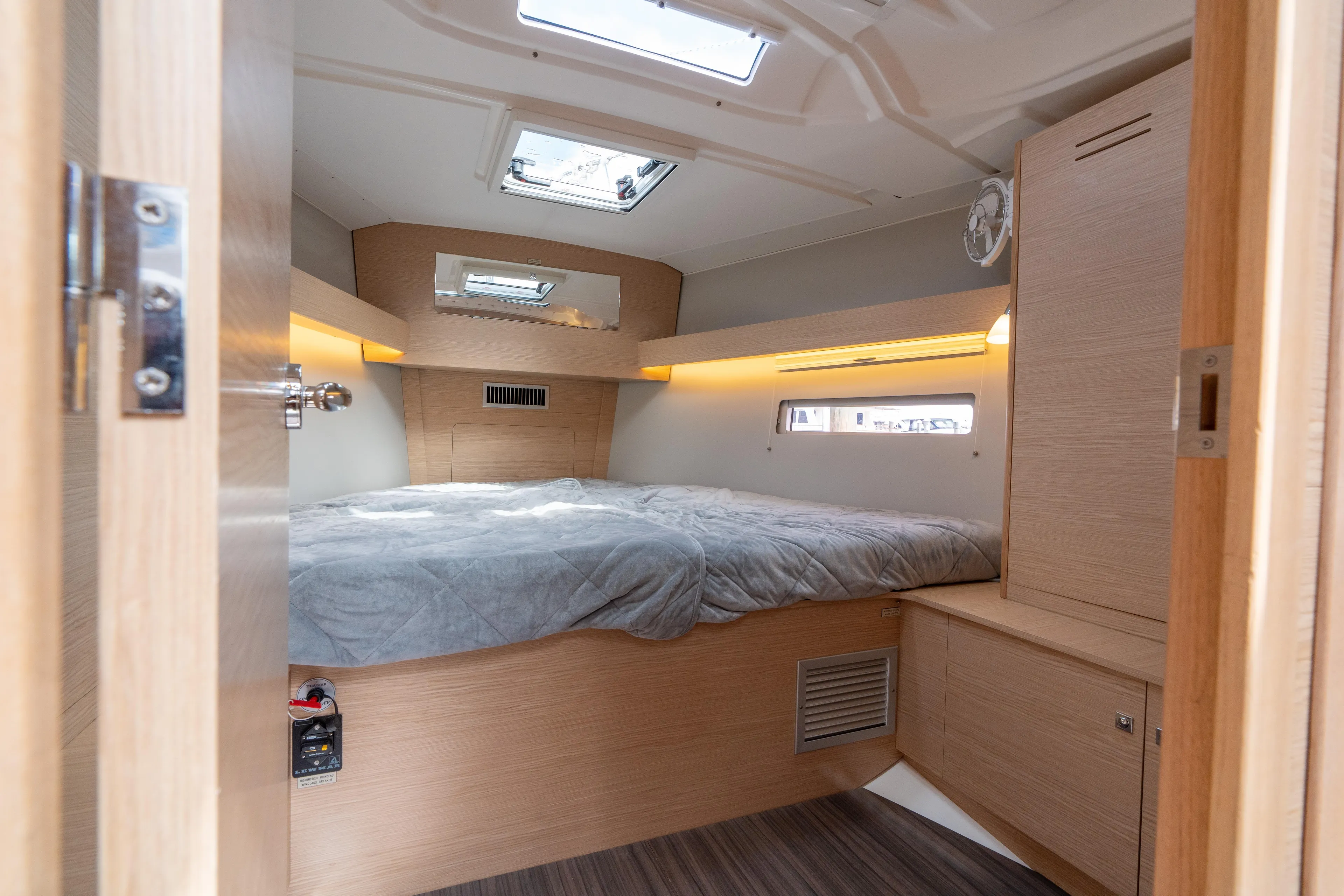 Lunar Sea Yacht Photos Pics Cozy cabin interior of 2023 Dufour 390 yacht with skylight and wooden furnishings.