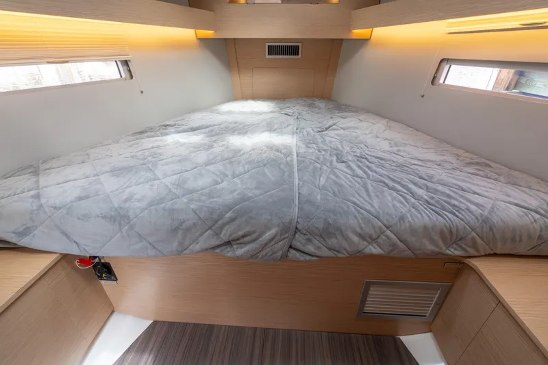 Lunar Sea Yacht Photos Pics 2023 Dufour 390 yacht interior cabin with cozy bed and modern lighting.