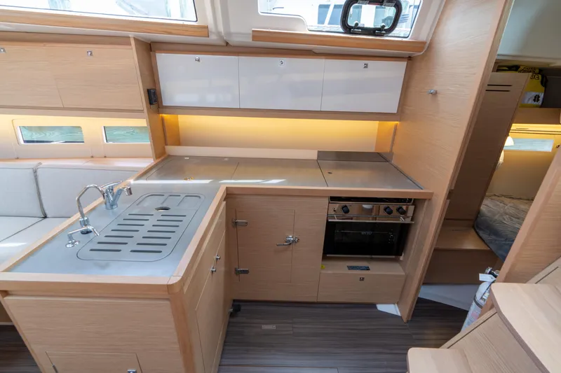Lunar Sea Yacht Photos Pics Modern kitchen interior of 2023 Dufour 390 yacht with sleek cabinetry and appliances.
