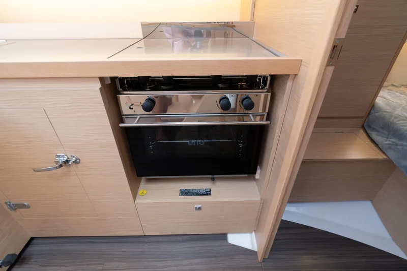 Lunar Sea Yacht Photos Pics Modern kitchen area in 2023 Dufour 390 yacht with sleek oven and wooden cabinetry.