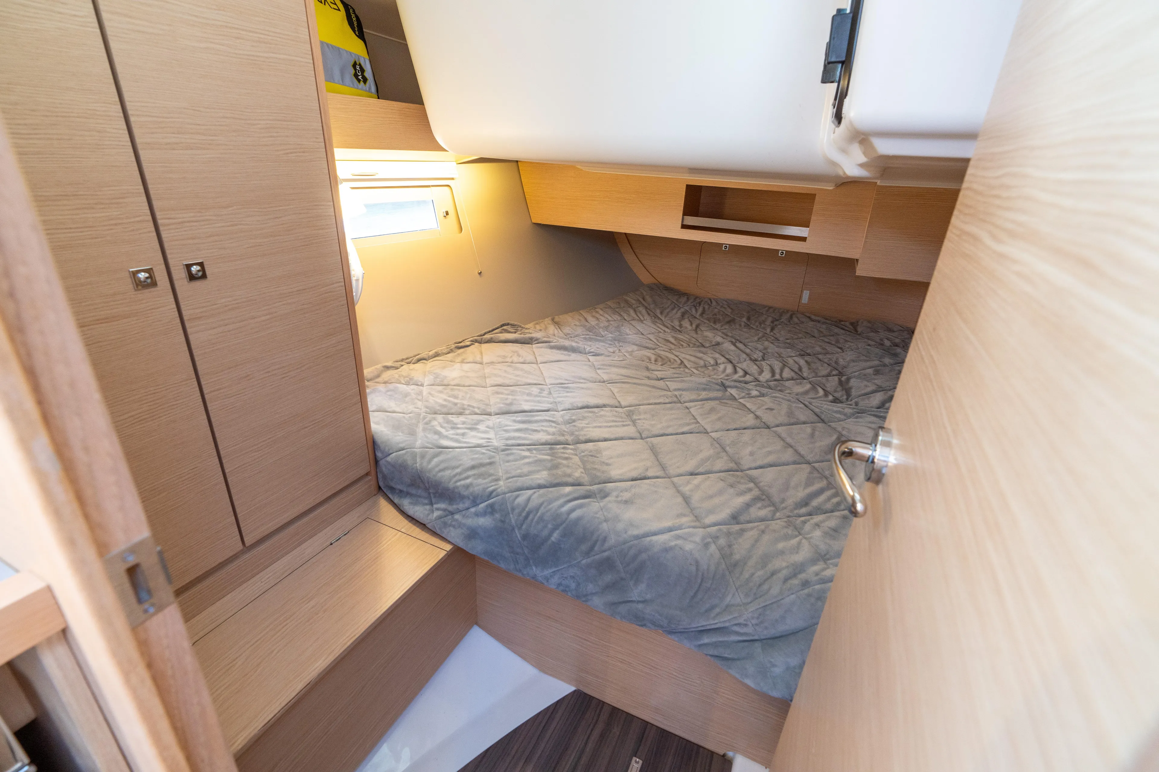 Lunar Sea Yacht Photos Pics 2023 Dufour 390 yacht cabin with cozy bed and wooden interior design.