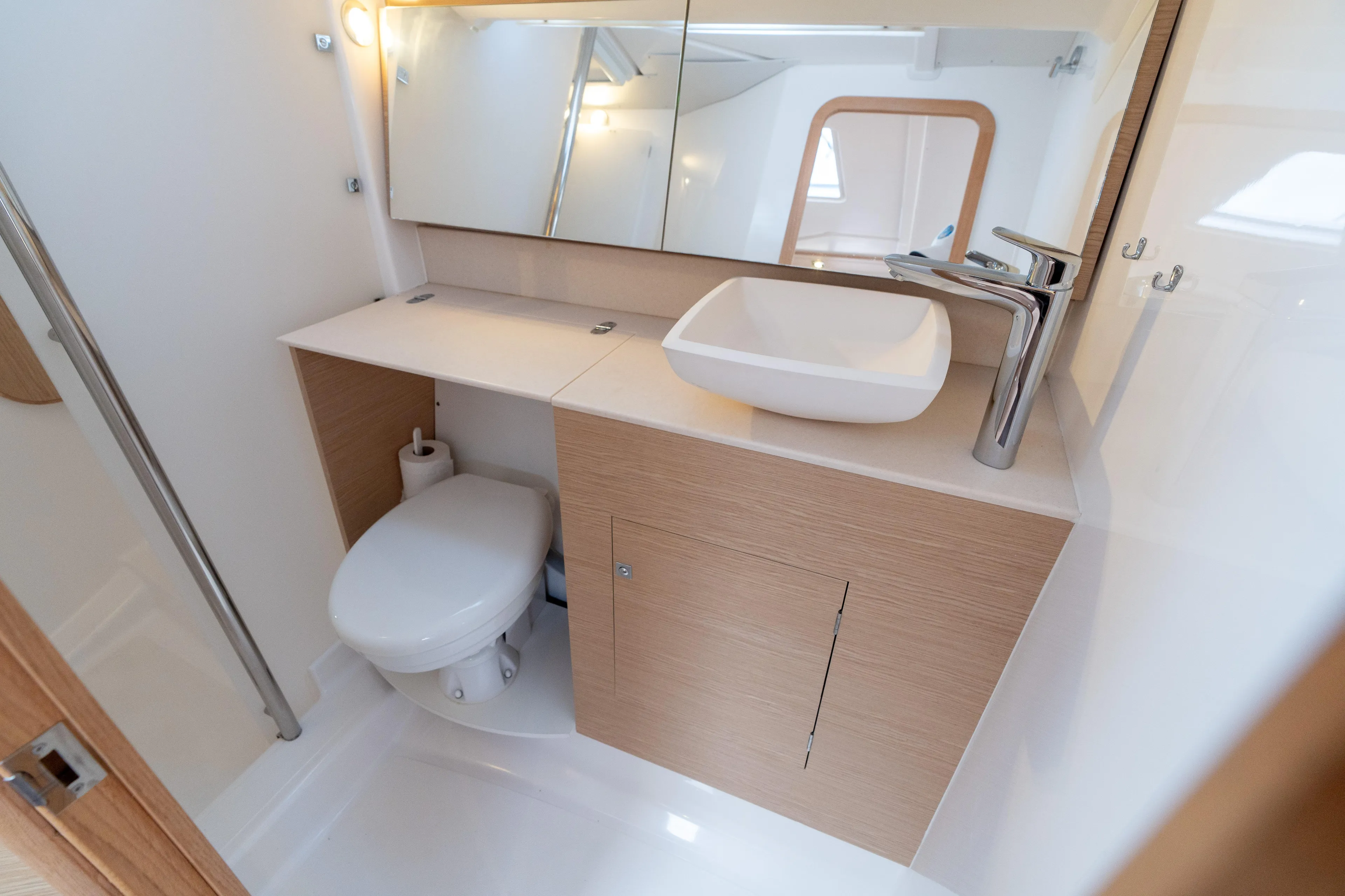 Lunar Sea Yacht Photos Pics Modern bathroom in 2023 Dufour 390 yacht with sleek fixtures and wooden cabinetry.
