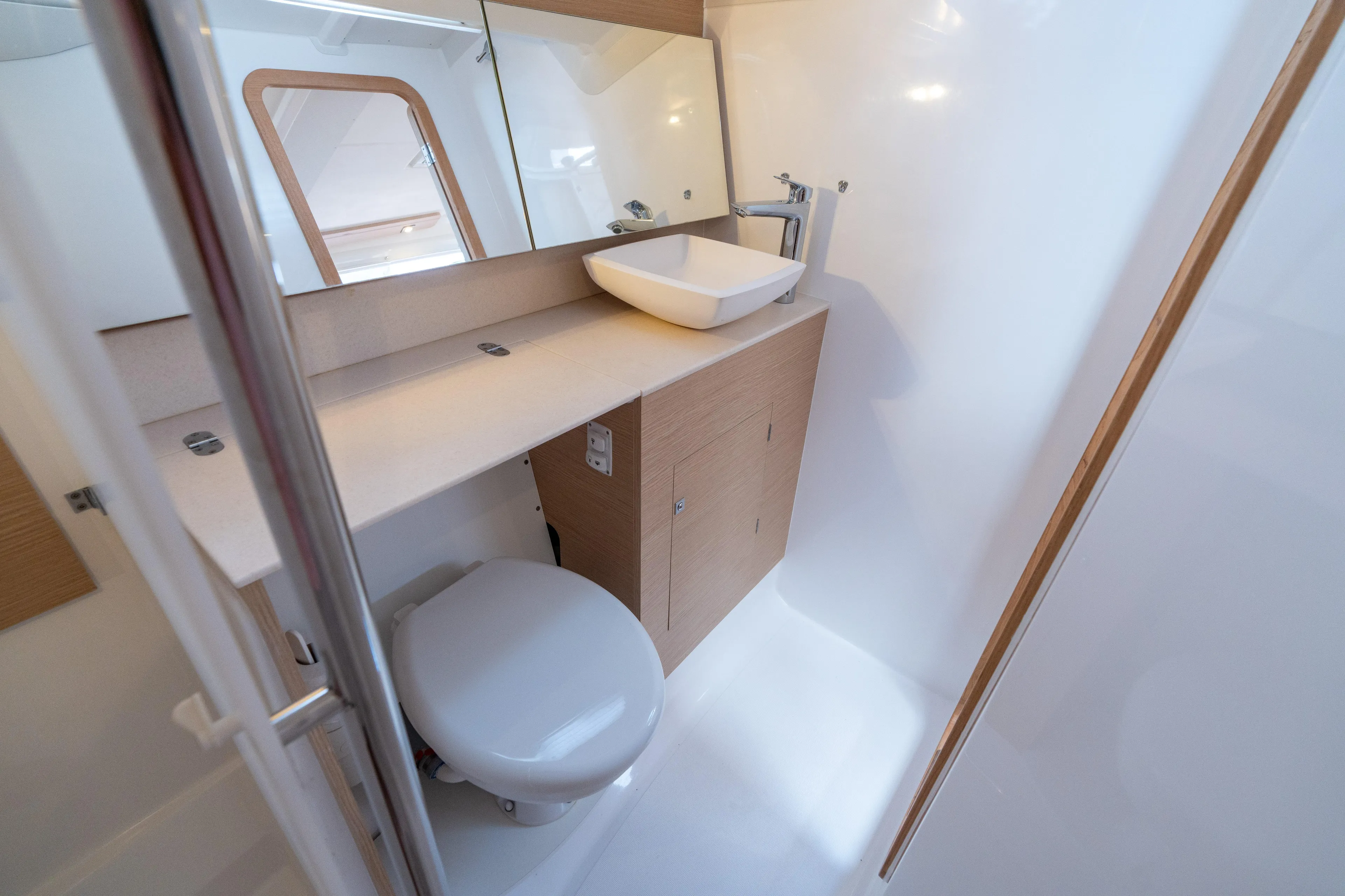 Lunar Sea Yacht Photos Pics Modern bathroom in 2023 Dufour 390 yacht, featuring sleek sink and mirror design.