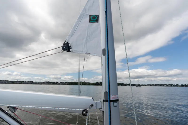 Lunar Sea Yacht Photos Pics Dufour 390 sailboat mast and sail on calm water, 2023 model.