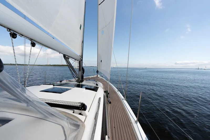 Lunar Sea Yacht Photos Pics 2023 Dufour 390 sailboat cruising on open water under clear skies.