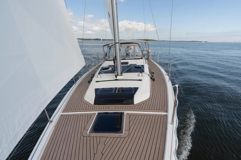 Lunar Sea Yacht Photos Pics 2023 Dufour 390 sailboat cruising on calm waters under clear skies.