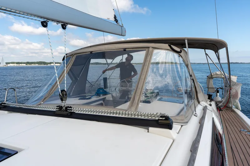 Lunar Sea Yacht Photos Pics 2023 Dufour 390 yacht sailing on calm waters under a clear blue sky.