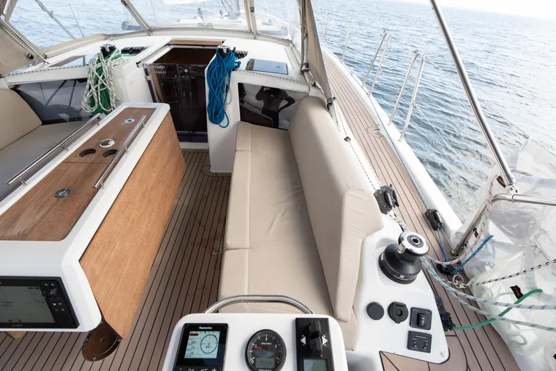 Lunar Sea Yacht Photos Pics 2023 Dufour 390 yacht cockpit with seating, navigation instruments, and ocean view.
