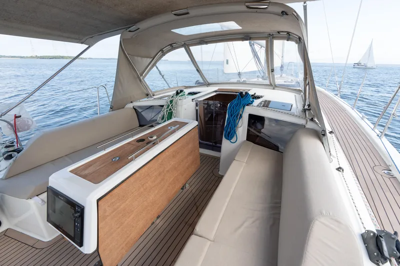 Lunar Sea Yacht Photos Pics 2023 Dufour 390 yacht cockpit with beige seating and ocean view.