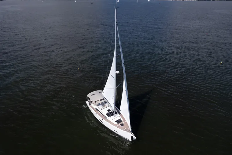 Lunar Sea Yacht Photos Pics 2023 Dufour 390 sailboat cruising on open water, aerial view.