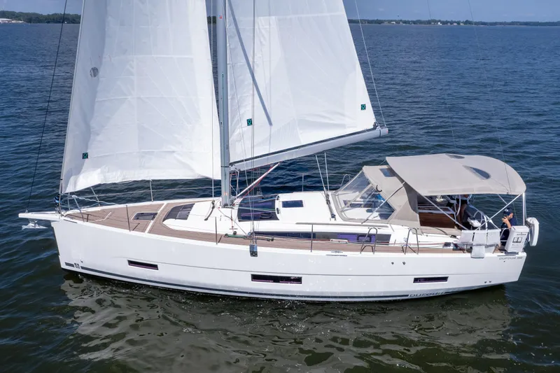 Lunar Sea Yacht Photos Pics 2023 Dufour 390 sailboat cruising on open water under clear skies.