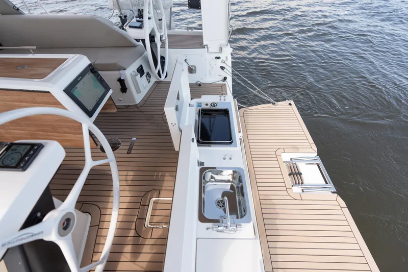 Lunar Sea Yacht Photos Pics 2023 Dufour 390 yacht deck with steering wheel, navigation equipment, and outdoor sink.