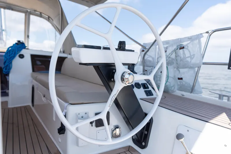 Lunar Sea Yacht Photos Pics Steering wheel of 2023 Dufour 390 sailboat, featuring modern design and spacious cockpit.