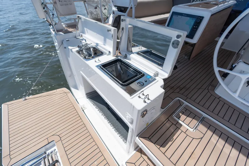 Lunar Sea Yacht Photos Pics 2023 Dufour 390 yacht deck with outdoor kitchen and navigation controls.