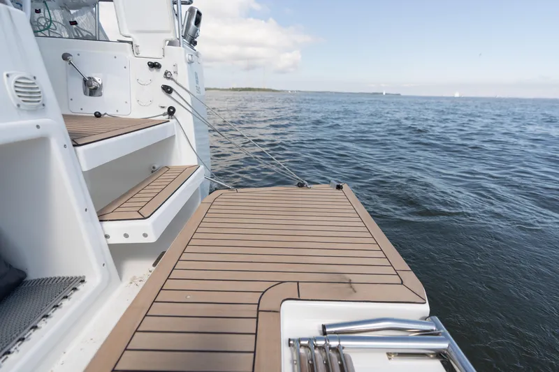 Lunar Sea Yacht Photos Pics 2023 Dufour 390 yacht deck with ocean view, featuring sleek wooden finish.