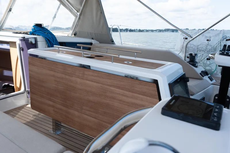 Lunar Sea Yacht Photos Pics 2023 Dufour 390 yacht cockpit with wooden table and navigation equipment.