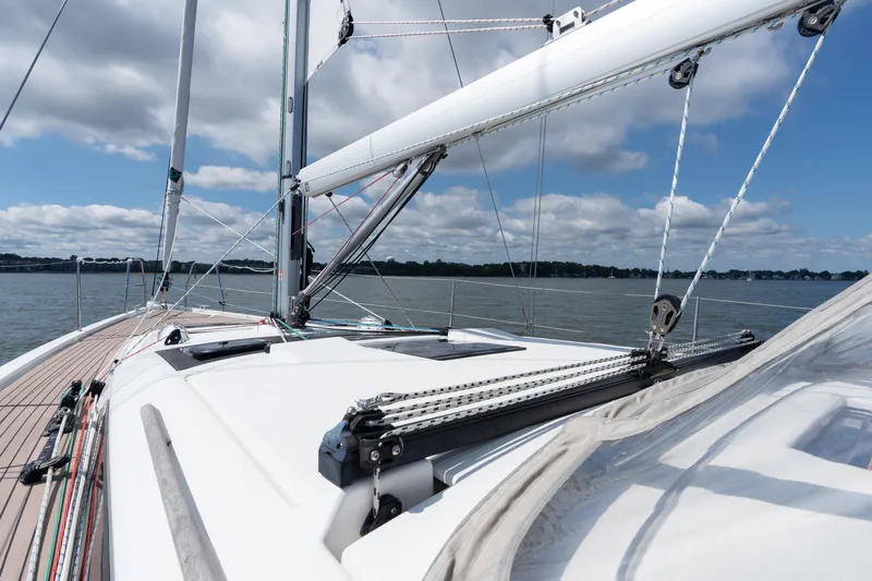 Lunar Sea Yacht Photos Pics 2023 Dufour 390 sailboat deck with rigging, sailing on calm waters under a cloudy sky.