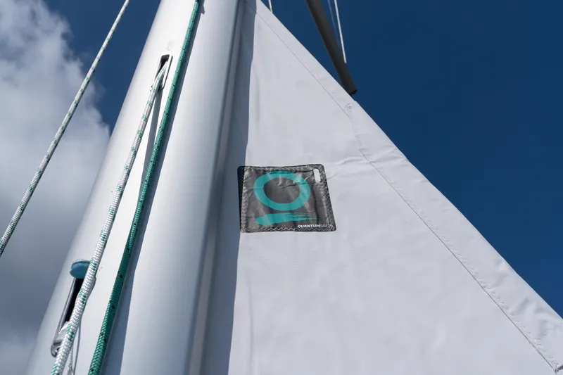 Lunar Sea Yacht Photos Pics Sail of 2023 Dufour 390 yacht with Quantum Sails logo against blue sky.