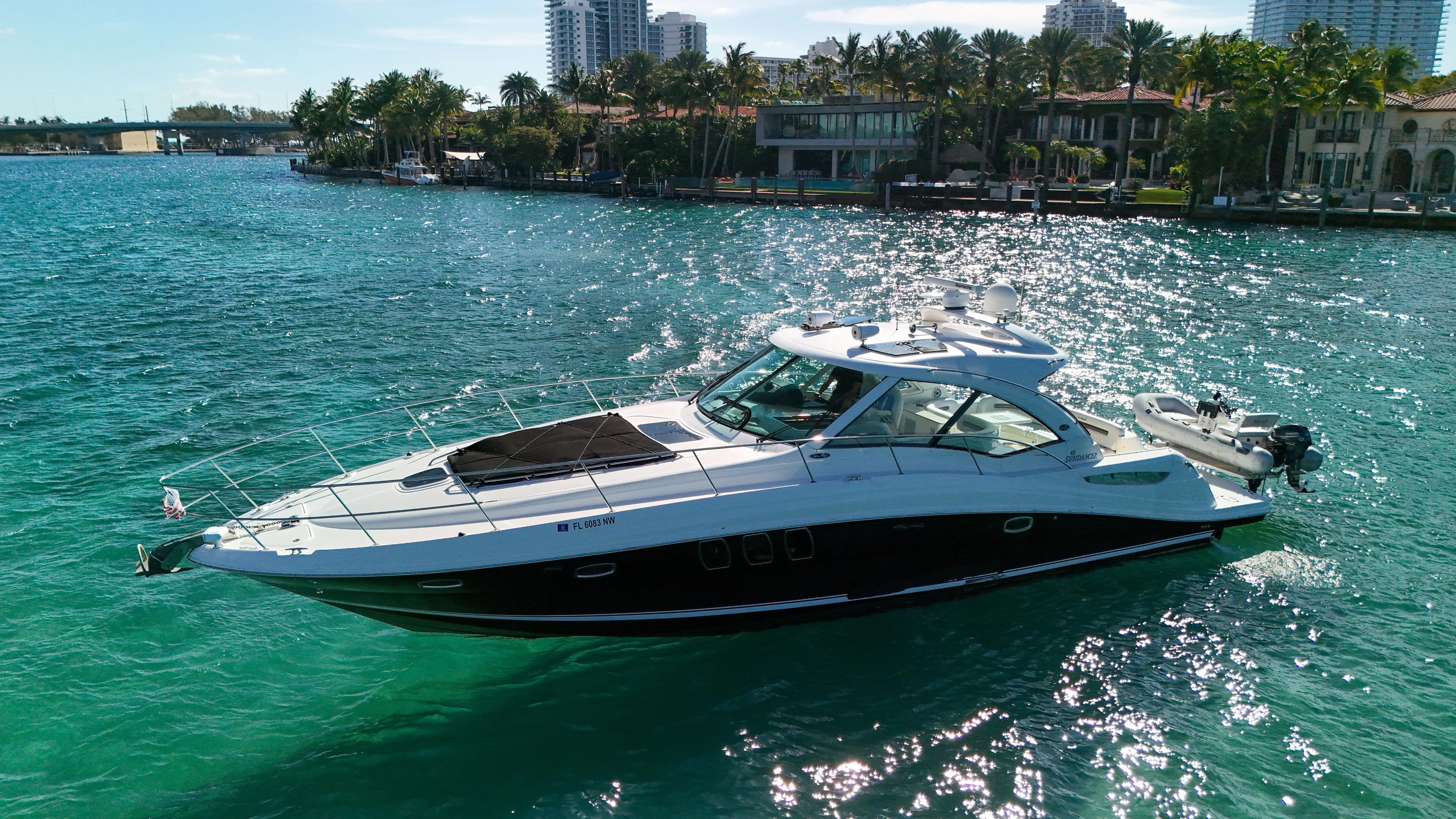 Morena Yacht Photos Pics 2008 Sea Ray 48 Sundancer yacht cruising on clear blue water near a tropical shoreline.