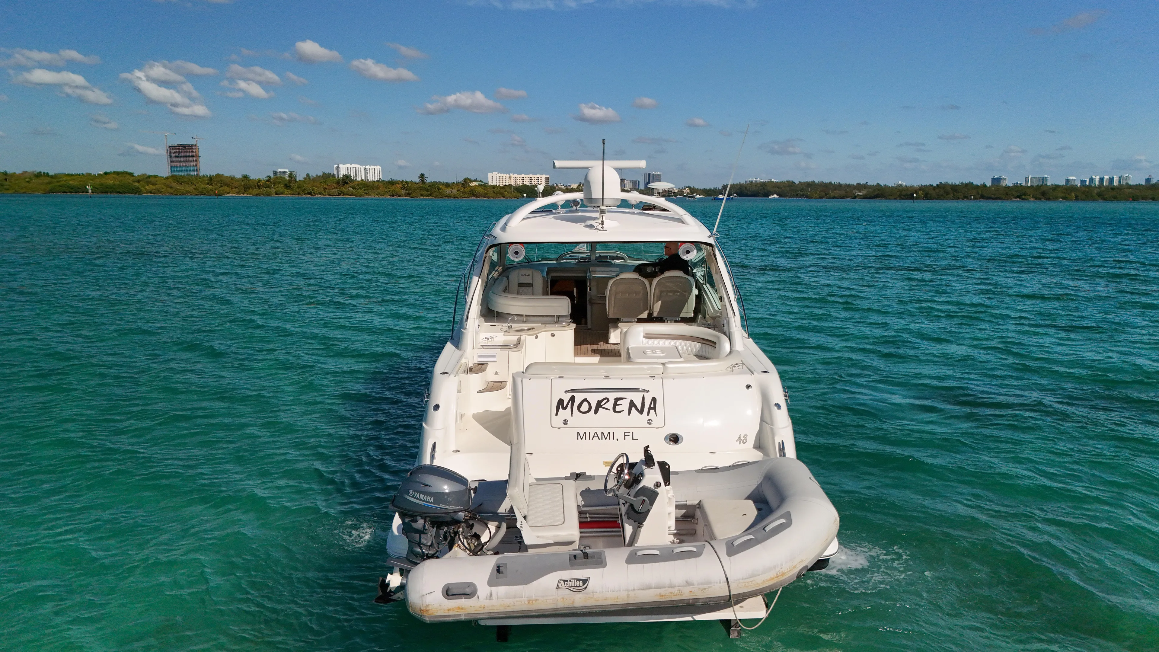 Morena Yacht Photos Pics 2008 Sea Ray 48 Sundancer yacht on turquoise water, rear view.