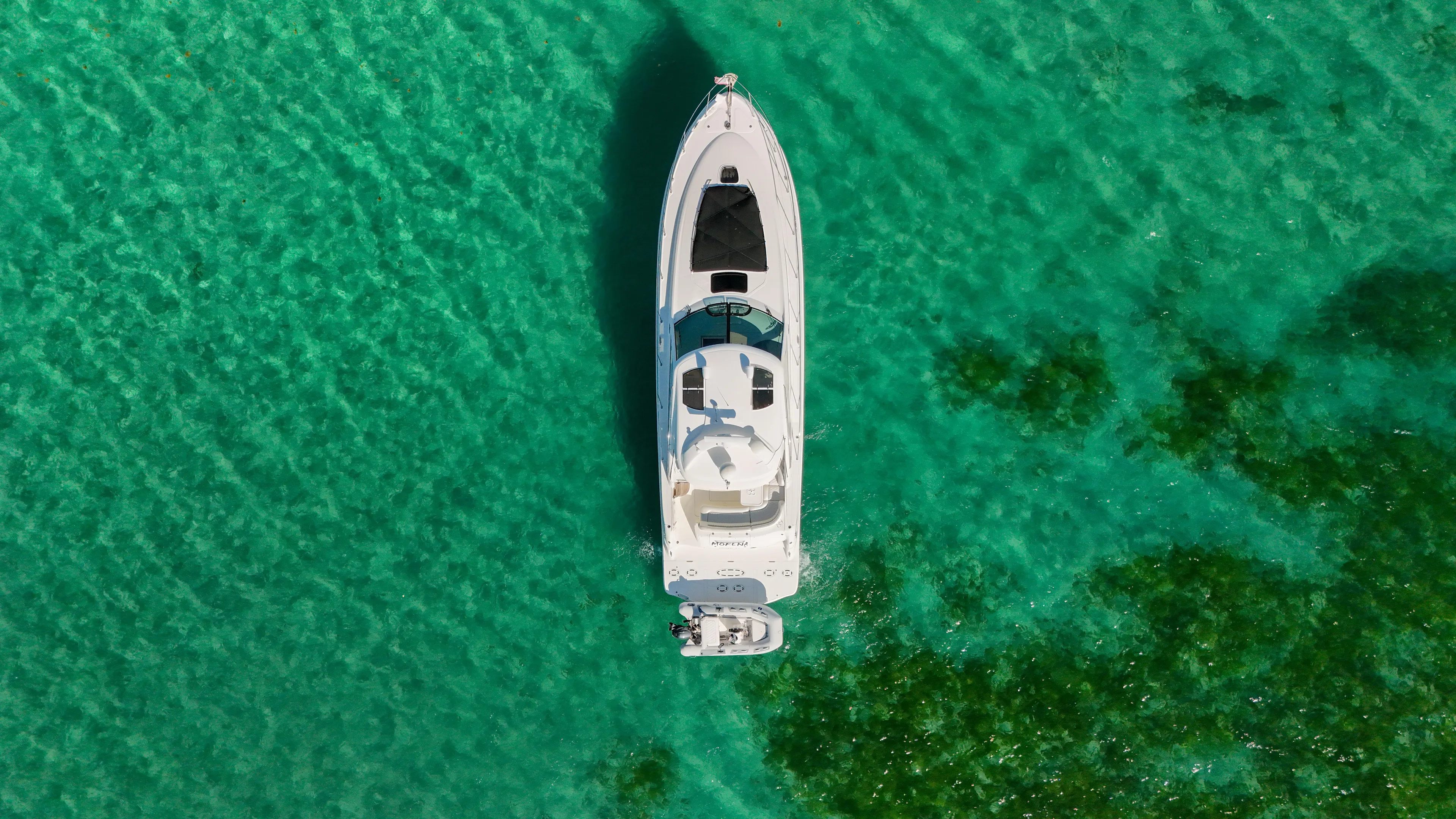 Morena Yacht Photos Pics Aerial view of 2008 Sea Ray 48 Sundancer yacht on clear turquoise water.