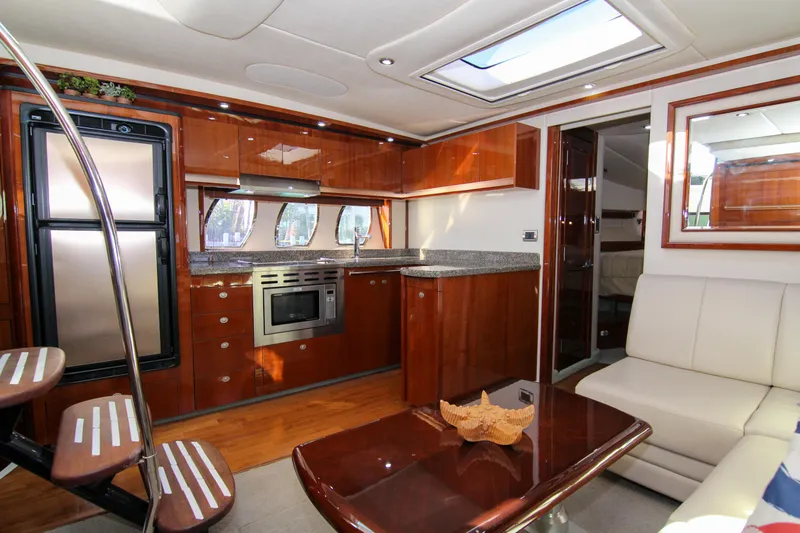 Morena Yacht Photos Pics Luxurious interior of 2008 Sea Ray 48 Sundancer yacht with modern kitchen and seating area.