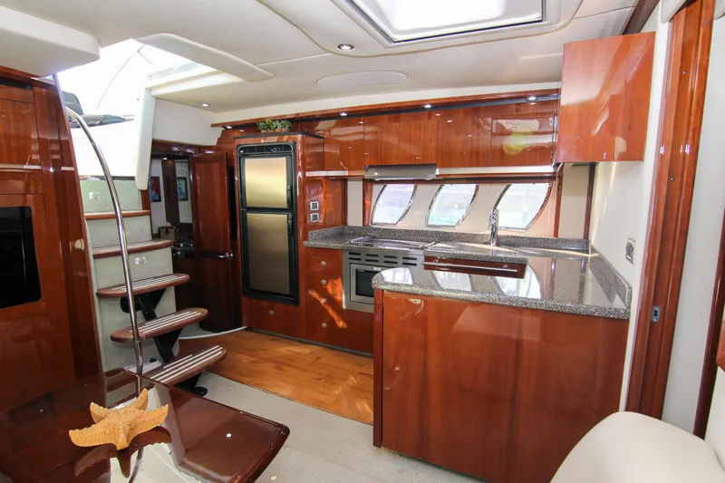 Morena Yacht Photos Pics Luxurious interior of 2008 Sea Ray 48 Sundancer yacht with modern kitchen and wooden finishes.