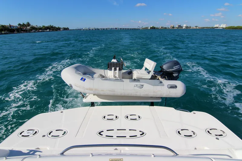 Morena Yacht Photos Pics 2008 Sea Ray 48 Sundancer with dinghy on blue ocean waters.