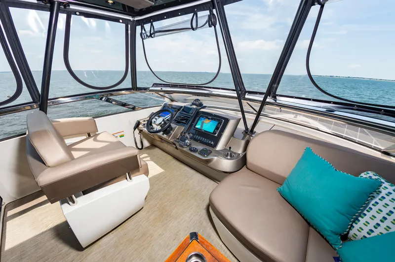 Docked Wages Yacht Photos Pics Interior of 2013 Marquis 63 Sport Yacht with helm, seating, and ocean view.