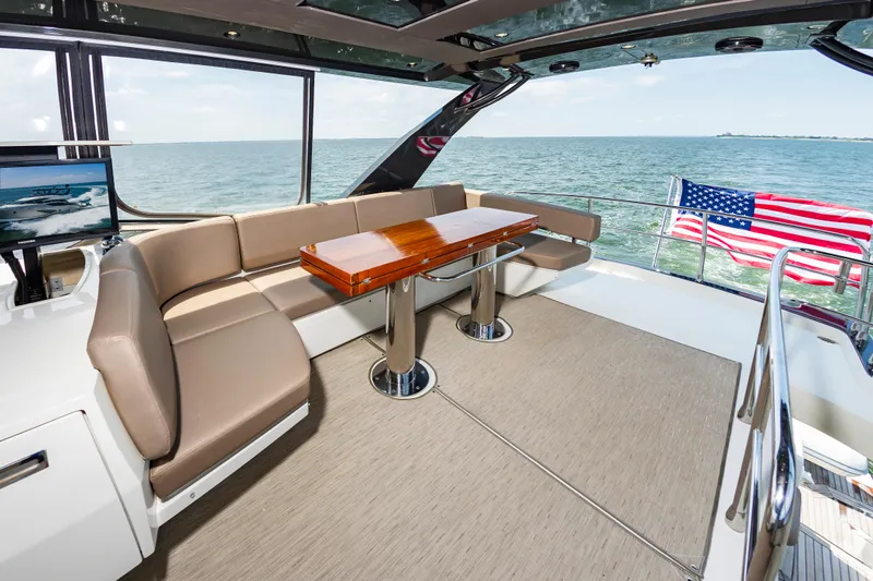 Docked Wages Yacht Photos Pics Luxurious 2013 Marquis 63 Sport Yacht interior with ocean view and American flag.