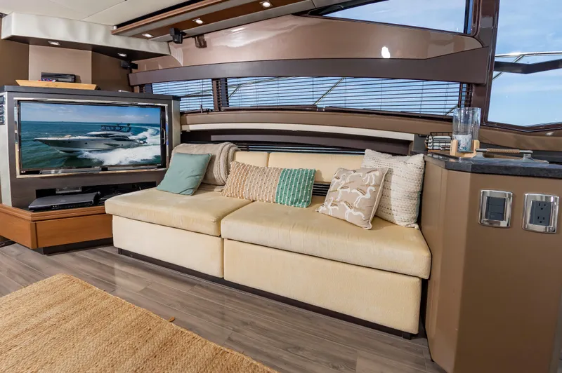 Docked Wages Yacht Photos Pics Luxurious interior of 2013 Marquis 63 Sport Yacht with cozy seating and large TV.