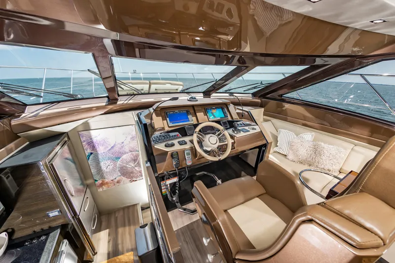 Docked Wages Yacht Photos Pics Luxurious interior of 2013 Marquis 63 Sport Yacht with modern helm and plush seating.