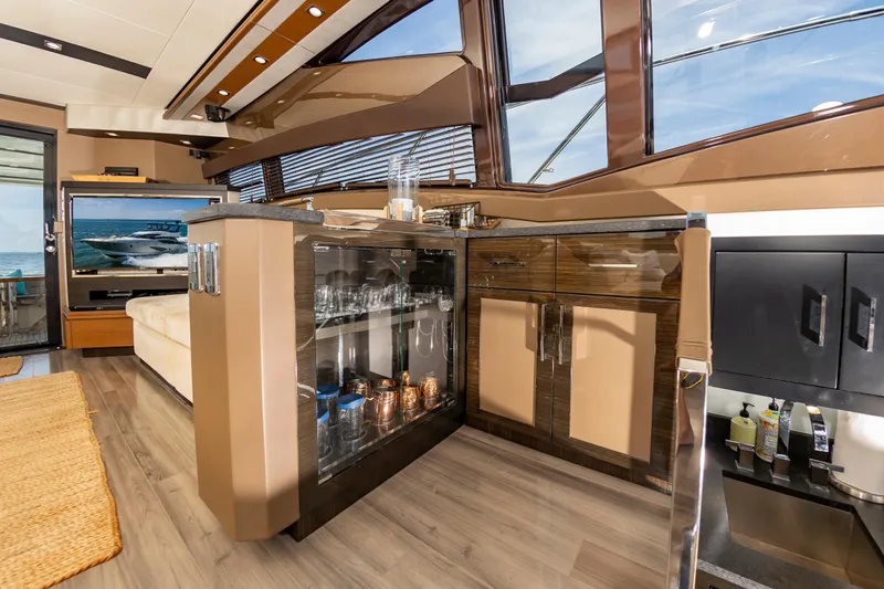 Docked Wages Yacht Photos Pics Luxurious interior of 2013 Marquis 63 Sport Yacht with modern cabinetry and glassware display.
