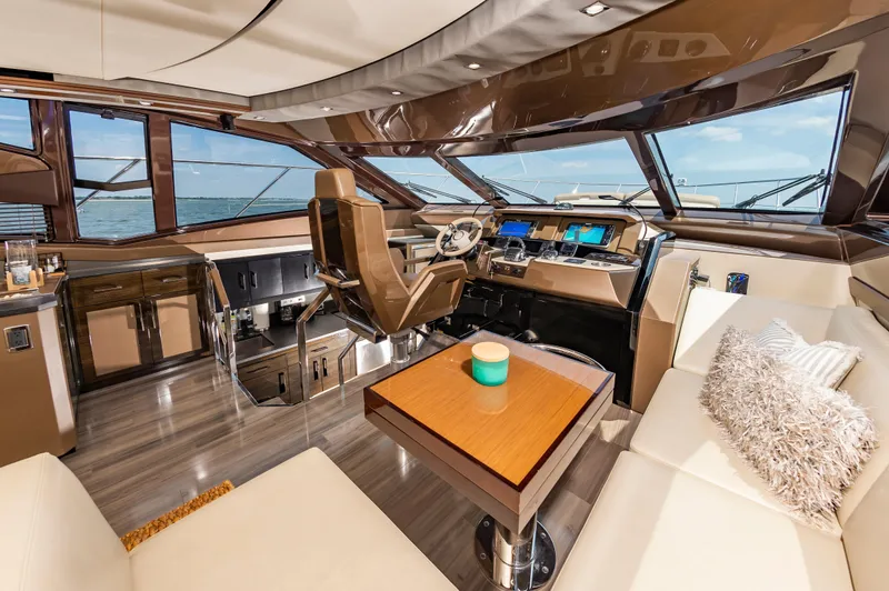 Docked Wages Yacht Photos Pics Luxurious interior of 2013 Marquis 63 Sport Yacht with modern helm and plush seating.