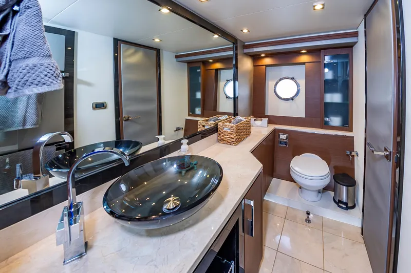 Docked Wages Yacht Photos Pics Luxurious bathroom in 2013 Marquis 63 Sport Yacht with modern fixtures and elegant design.