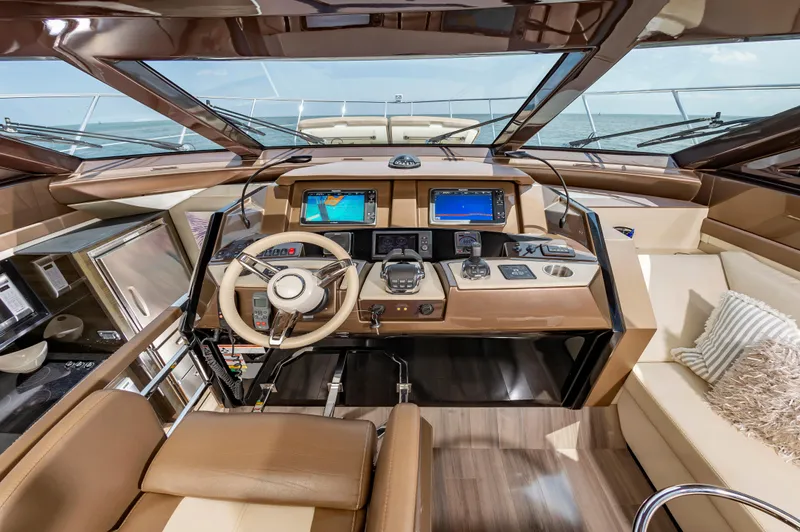Docked Wages Yacht Photos Pics Luxurious helm of 2013 Marquis 63 Sport Yacht with modern navigation systems.