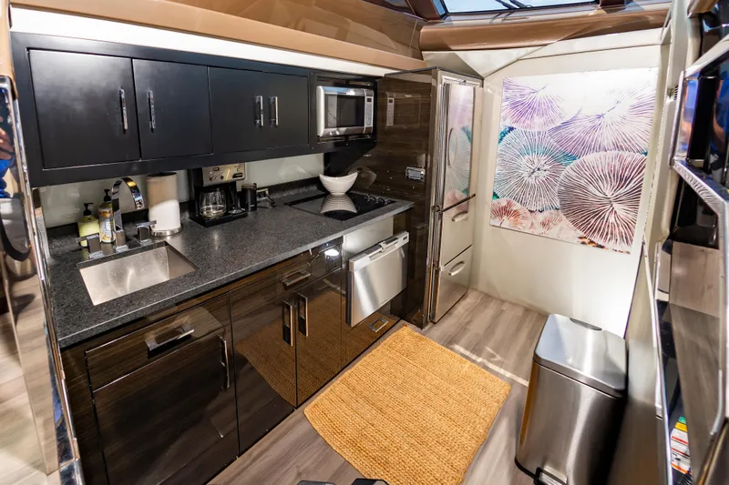 Docked Wages Yacht Photos Pics Modern kitchen interior of 2013 Marquis 63 Sport Yacht with sleek cabinetry and appliances.