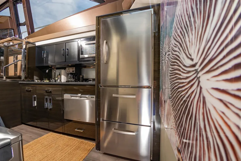 Docked Wages Yacht Photos Pics Modern kitchen interior of 2013 Marquis 63 Sport Yacht with stainless steel appliances.