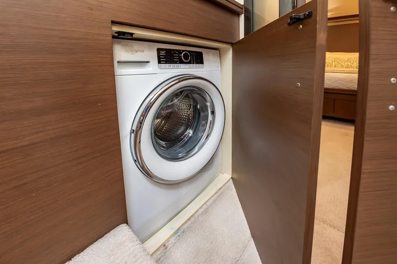 Docked Wages Yacht Photos Pics Built-in washing machine on 2013 Marquis 63 Sport Yacht, wooden cabinetry.