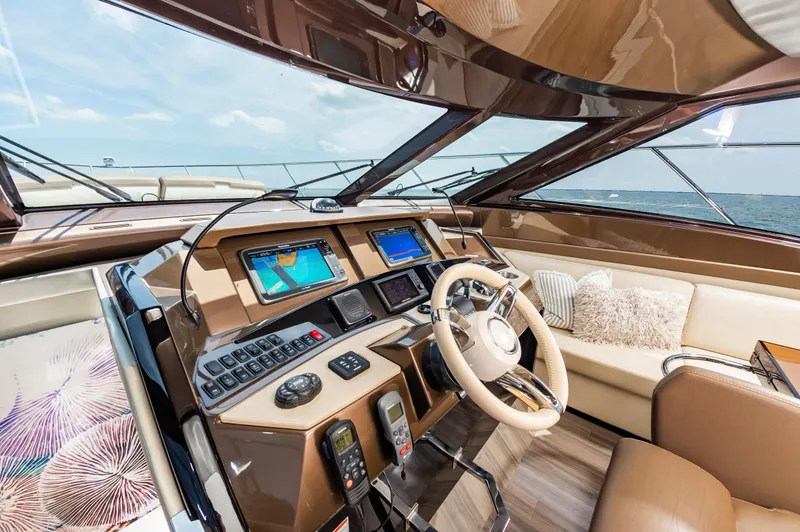 Docked Wages Yacht Photos Pics Luxurious 2013 Marquis 63 Sport Yacht helm with modern navigation systems and plush seating.