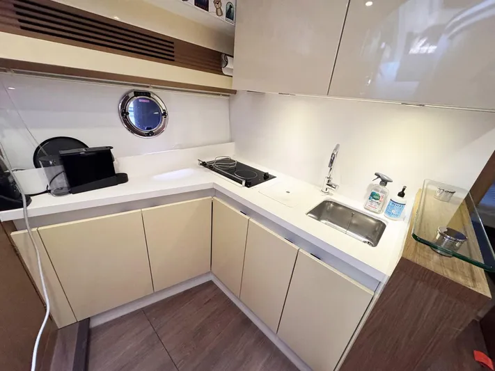 Wanderlust Yacht Photos Pics Modern kitchen in 2015 Beneteau Gran Turismo 44 yacht with sleek cabinetry and appliances.
