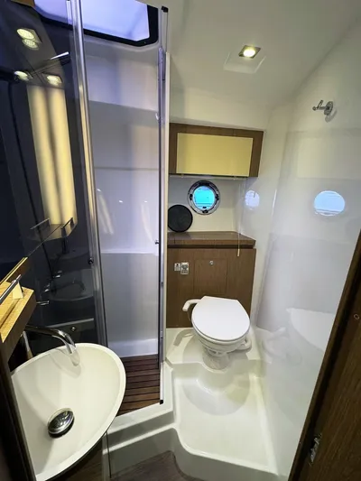 Wanderlust Yacht Photos Pics 2015 Beneteau Gran Turismo 44 yacht bathroom with modern fixtures and porthole window.