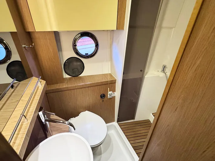 Wanderlust Yacht Photos Pics Bathroom interior of 2015 Beneteau Gran Turismo 44 yacht, featuring modern fixtures and porthole window.