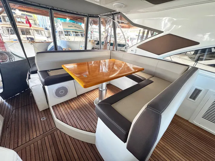 Wanderlust Yacht Photos Pics Luxurious seating area on 2015 Beneteau Gran Turismo 44 yacht with wooden table.