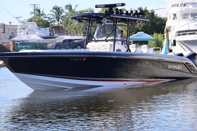  Yacht Photos Pics 2012 Donzi 38 ZF Open boat on calm water, sleek black design.